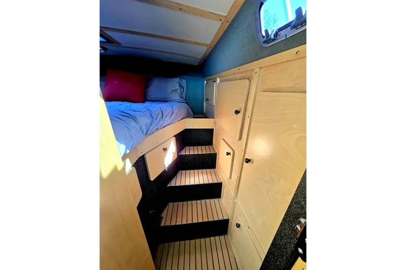 C Lady Yacht Photos Pics Interior of 2020 Armstrong Marine 35 boat with cozy bed and wooden cabinetry.