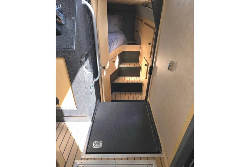 C Lady Yacht Photos Pics Interior of 2020 Armstrong Marine 35 boat with wooden steps and cozy sleeping area.