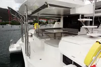 Leopard 50 yacht 2020 model, spacious deck with seating and dining area, docked in marina.