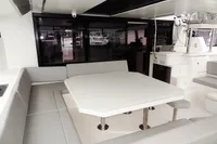 Modern dining area on a 2020 Leopard 50 yacht with white table and gray seating.