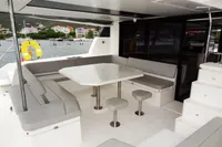 Leopard 50 yacht 2020 model, spacious outdoor seating area with table and stools.