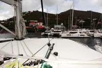 View from Leopard 50 yacht, docked in a marina with hills and buildings in the background.