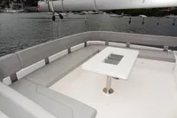 2020 Leopard 50 yacht with spacious outdoor seating and table, docked in a marina.