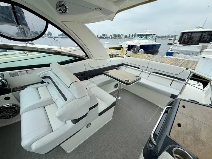$30k Price Reduction! Yacht Photos Pics 2020 Formula 350 Sun Sport yacht interior with white seating and table, docked at marina.