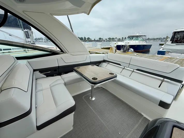 $30k Price Reduction! Yacht Photos Pics 2020 Formula 350 Sun Sport boat interior with sleek seating and table, docked at marina.