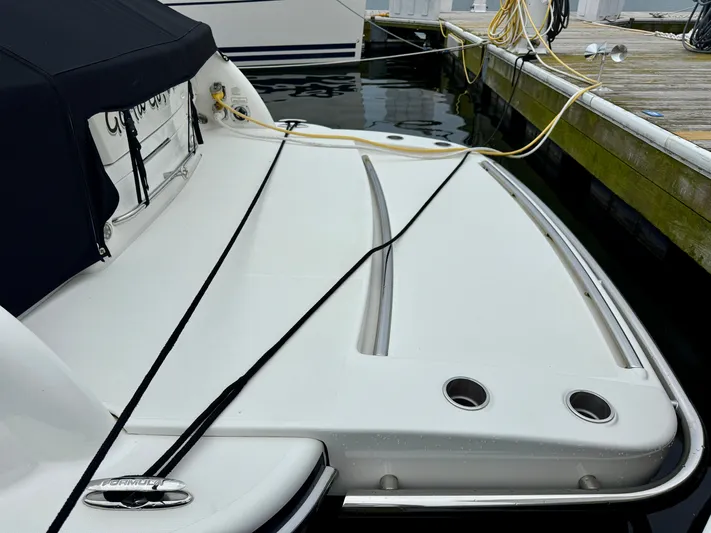 $30k Price Reduction! Yacht Photos Pics 2020 Formula 350 Sun Sport boat docked, featuring sleek design and covered seating area.