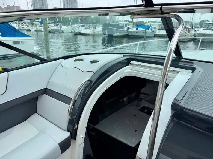 $30k Price Reduction! Yacht Photos Pics 2020 Formula 350 Sun Sport boat interior at marina, featuring seating and cabin entrance.