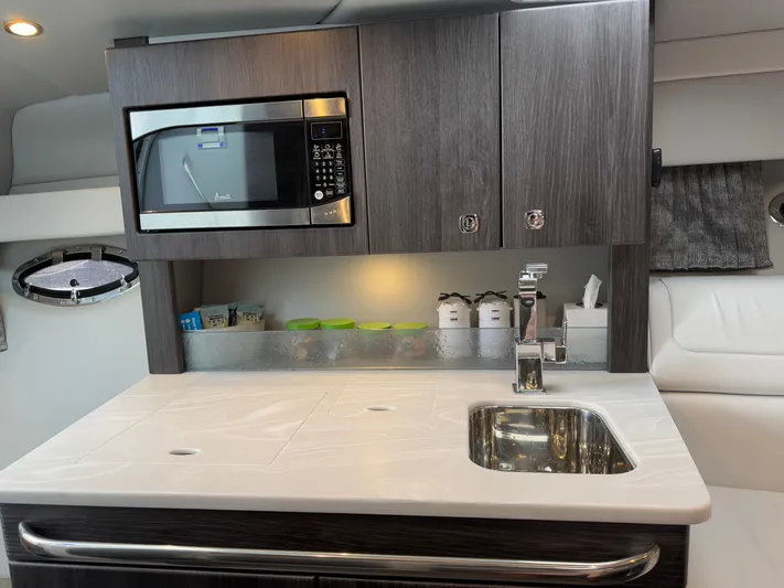 $30k Price Reduction! Yacht Photos Pics Modern kitchenette in 2020 Formula 350 Sun Sport boat with microwave and sink.