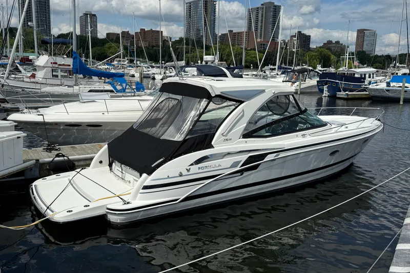 $30k Price Reduction! Yacht Photos Pics 2020 Formula 350 Sun Sport boat docked in a marina with city skyline background.