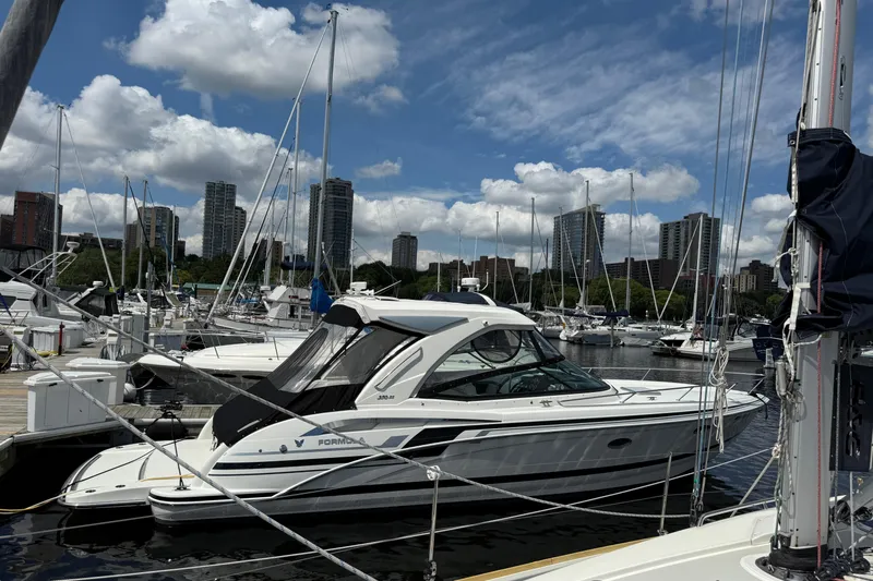 $30k Price Reduction! Yacht Photos Pics 2020 Formula 350 Sun Sport yacht docked in a marina with city skyline.