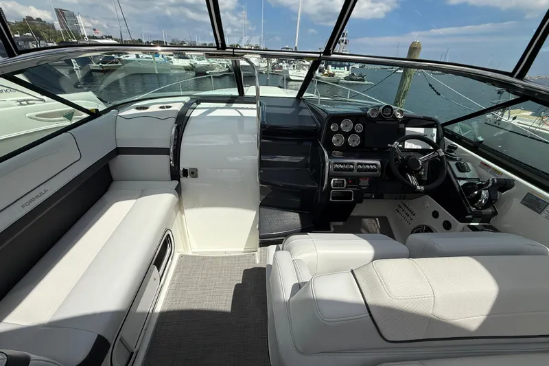 $30k Price Reduction! Yacht Photos Pics 2020 Formula 350 Sun Sport boat interior with helm, seating, and marina view.