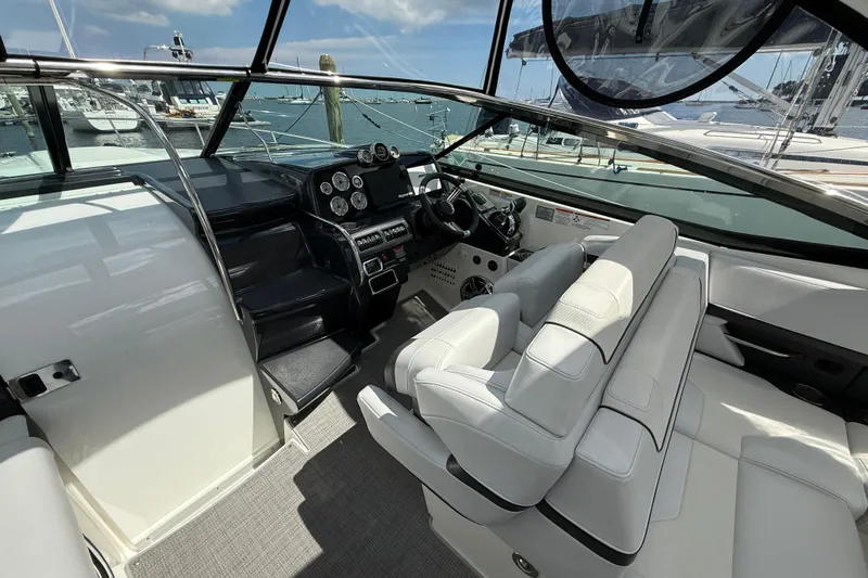$30k Price Reduction! Yacht Photos Pics 2020 Formula 350 Sun Sport boat interior with modern dashboard and white seating.
