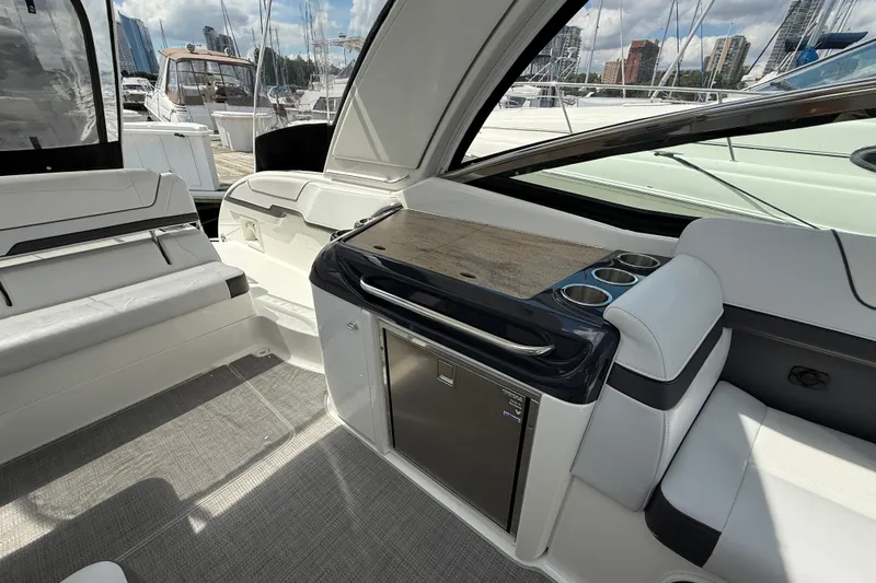 $30k Price Reduction! Yacht Photos Pics 2020 Formula 350 Sun Sport boat interior with seating and kitchenette, docked at marina.