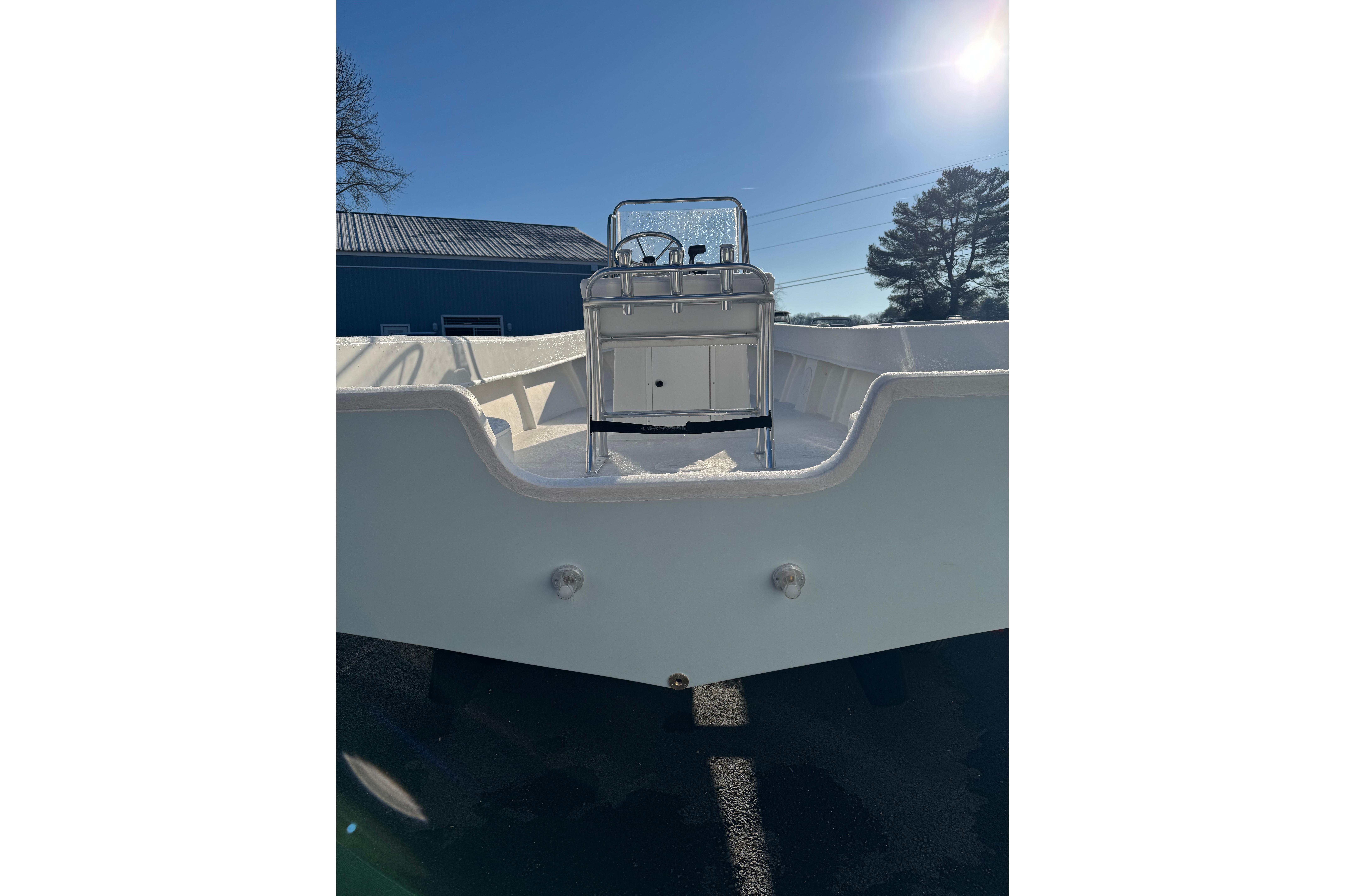 2026 C-Hawk 200 Center Console boat, viewed from the stern under bright sunlight.