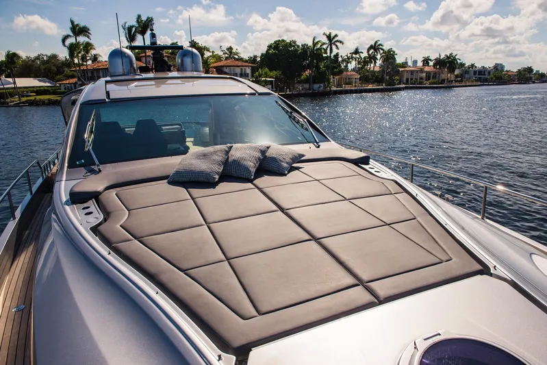 Argo Yacht Photos Pics Luxurious 2017 Pershing 70 yacht with sunbathing deck, docked by waterfront homes.