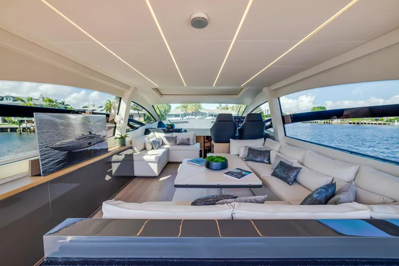 Argo Yacht Photos Pics Luxurious interior of a 2017 Pershing 70 yacht with modern seating and panoramic windows.