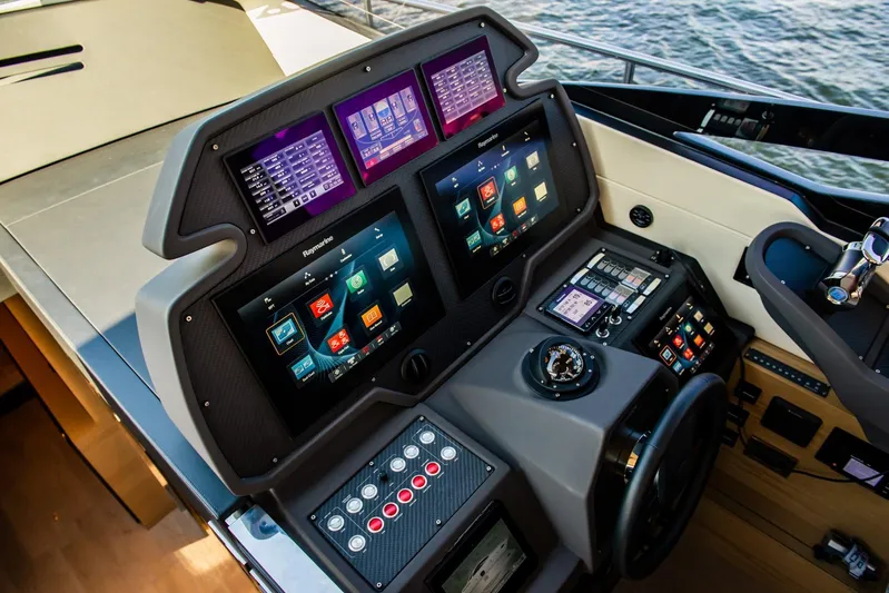 Argo Yacht Photos Pics Control panel of a 2017 Pershing 70 yacht with advanced navigation displays.
