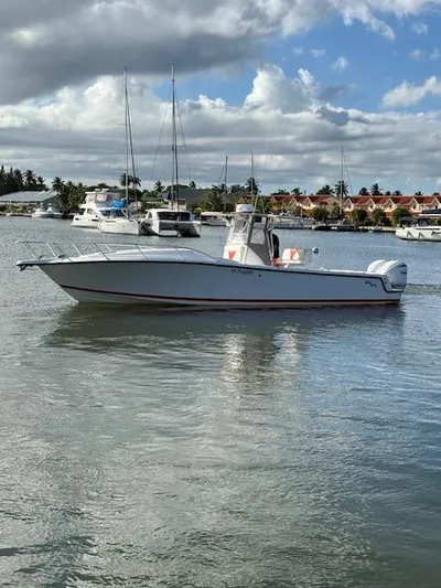 Wapala Yacht Photos Pics 2004 SeaVee 34 Center Console boat on calm water with marina background.
