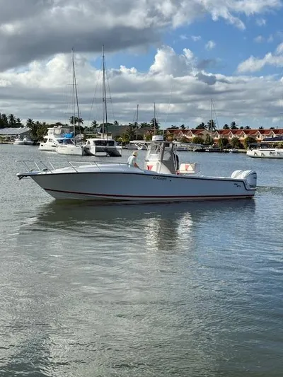 Wapala Yacht Photos Pics 2004 SeaVee 34 Center Console boat on calm water, with marina and cloudy sky background.