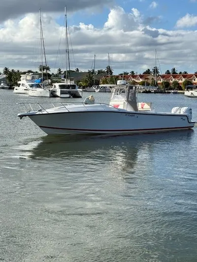 Wapala Yacht Photos Pics 2004 SeaVee 34 Center Console boat on calm water, with marina and cloudy sky background.