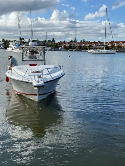 Wapala Yacht Photos Pics 2004 SeaVee 34 Center Console boat on calm water, with scenic marina backdrop.