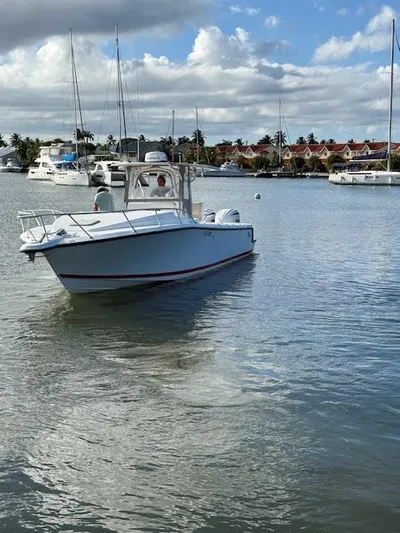 Wapala Yacht Photos Pics 2004 SeaVee 34 Center Console boat on calm water, with marina and cloudy sky background.