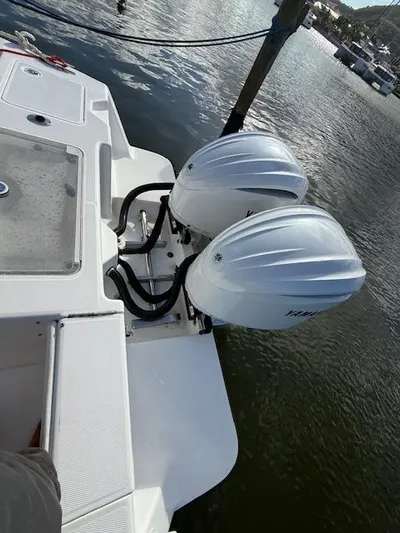 Wapala Yacht Photos Pics 2004 SeaVee 34 Center Console with dual outboard engines docked by the water.