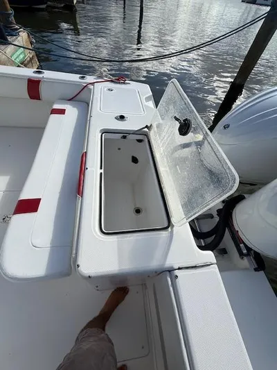 Wapala Yacht Photos Pics 2004 SeaVee 34 Center Console boat with open storage compartment, docked by the water.