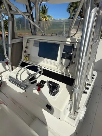 Wapala Yacht Photos Pics 2004 SeaVee 34 Center Console helm with steering wheel, controls, and navigation screen.