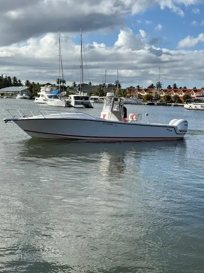 Wapala Yacht Photos Pics 2004 SeaVee 34 Center Console boat on calm water, with a scenic marina backdrop.