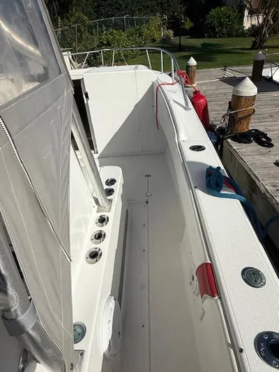 Wapala Yacht Photos Pics 2004 SeaVee 34 Center Console boat docked, featuring spacious deck and fishing rod holders.