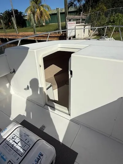 Wapala Yacht Photos Pics 2004 SeaVee 34 Center Console boat with open cabin door, dockside view.