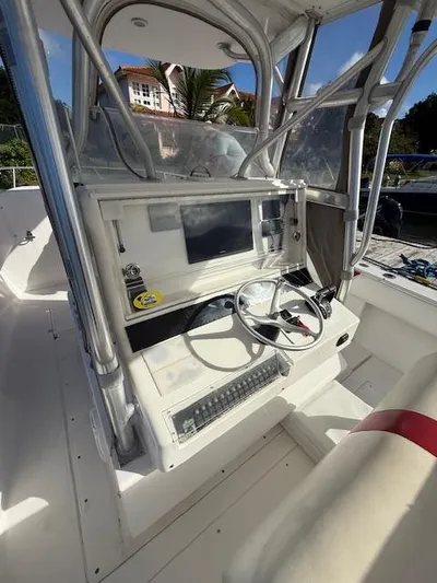 Wapala Yacht Photos Pics 2004 SeaVee 34 Center Console boat helm with steering wheel and navigation display.