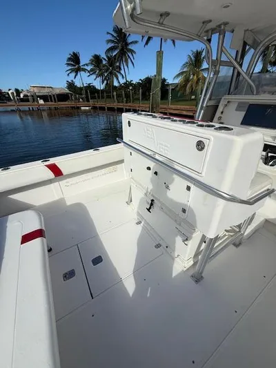 Wapala Yacht Photos Pics 2004 SeaVee 34 Center Console boat with spacious deck and palm trees in the background.