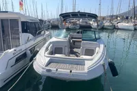 2016 Crownline Eclipse E2 XS boat docked in a marina, surrounded by sailboats.