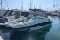2016 Crownline Eclipse E2 XS boat docked in a marina, surrounded by other vessels.