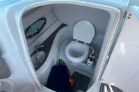Compact marine bathroom in 2016 Crownline Eclipse E2 XS boat, featuring toilet and sink.