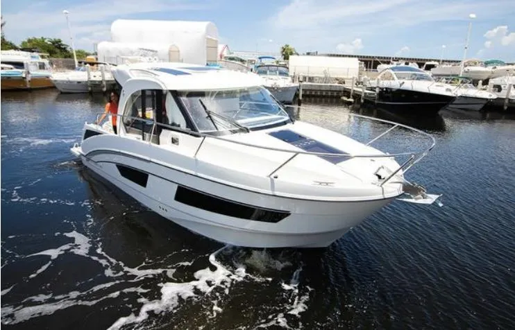  Yacht Photos Pics 2021 Beneteau Antares boat docked in a marina under a clear blue sky.