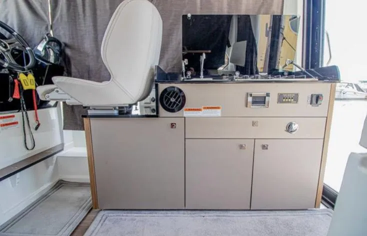  Yacht Photos Pics Interior of 2021 Beneteau Antares boat, featuring helm station and seating area.