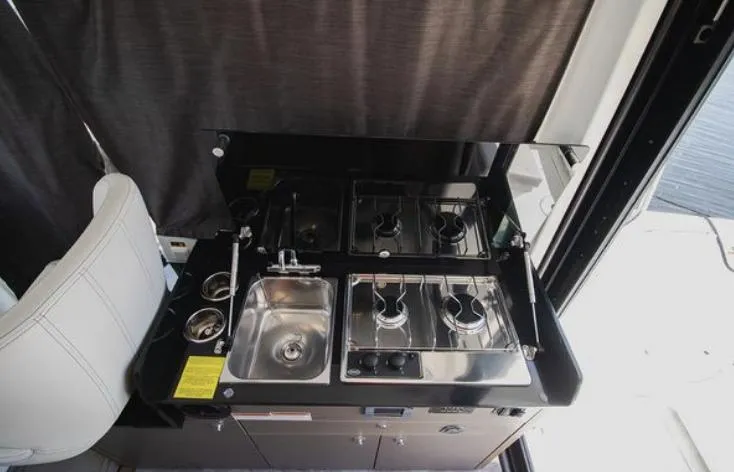  Yacht Photos Pics 2021 Beneteau Antares kitchen area with stove and sink.