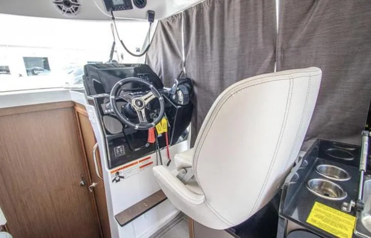  Yacht Photos Pics 2021 Beneteau Antares helm station with steering wheel and captain's chair.
