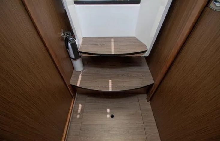  Yacht Photos Pics Interior stairs of 2021 Beneteau Antares boat with wooden finish.