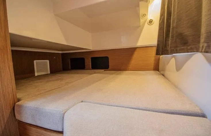  Yacht Photos Pics 2021 Beneteau Antares cabin interior with cozy sleeping area and modern design.