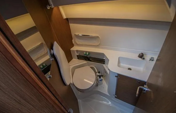  Yacht Photos Pics 2021 Beneteau Antares bathroom with modern fixtures and compact design.