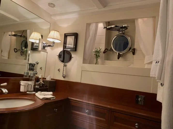 Iduna Yacht Photos Pics Luxurious 1939 Feadship Classic Yacht bathroom with elegant wood finish and nautical decor.