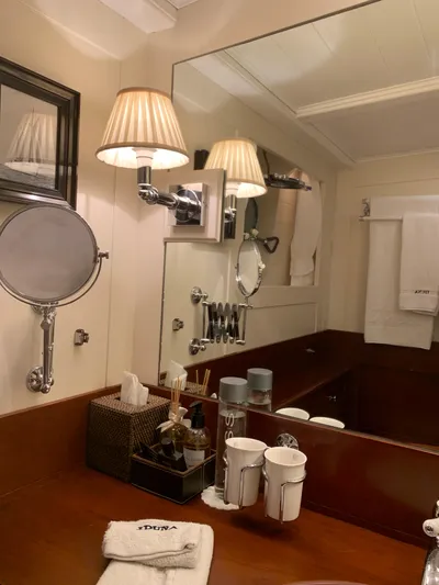 Iduna Yacht Photos Pics Luxurious bathroom on 1939 Feadship Classic Sailing Yacht with elegant fixtures and warm lighting.