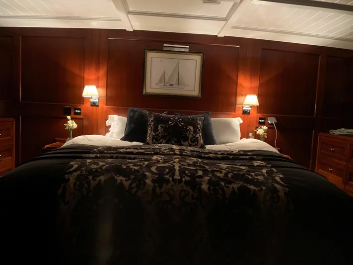 Iduna Yacht Photos Pics Luxurious bedroom interior on 1939 Feadship Classic Sailing Yacht with elegant wood paneling.