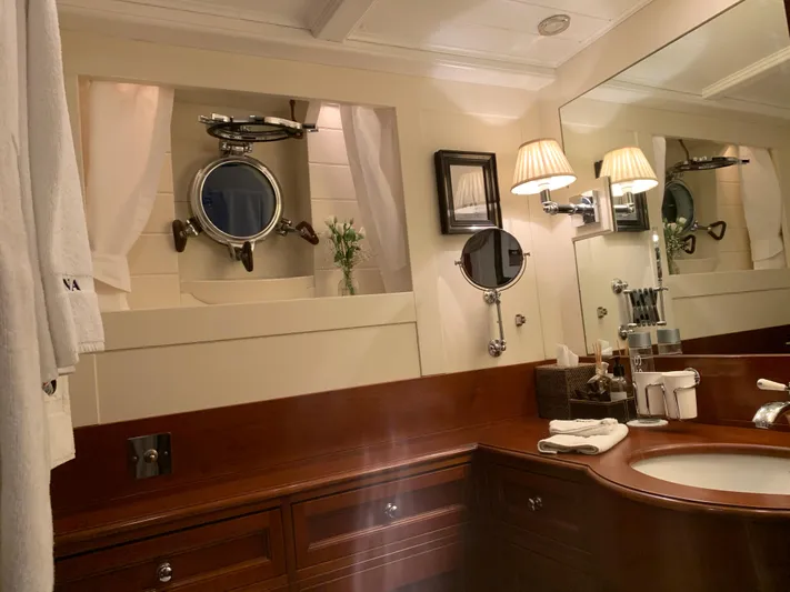 Iduna Yacht Photos Pics Luxurious 1939 Feadship Classic Sailing Yacht bathroom with elegant wood finish and nautical decor.