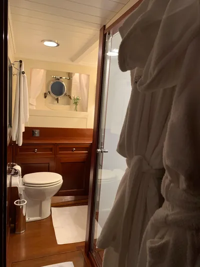 Iduna Yacht Photos Pics Luxurious bathroom on 1939 Feadship Classic Sailing Yacht with elegant wood finishes.