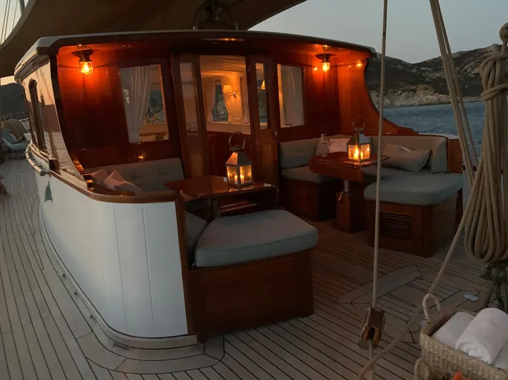 Iduna Yacht Photos Pics Classic 1939 Feadship sailing yacht with elegant wooden deck and cozy seating area.